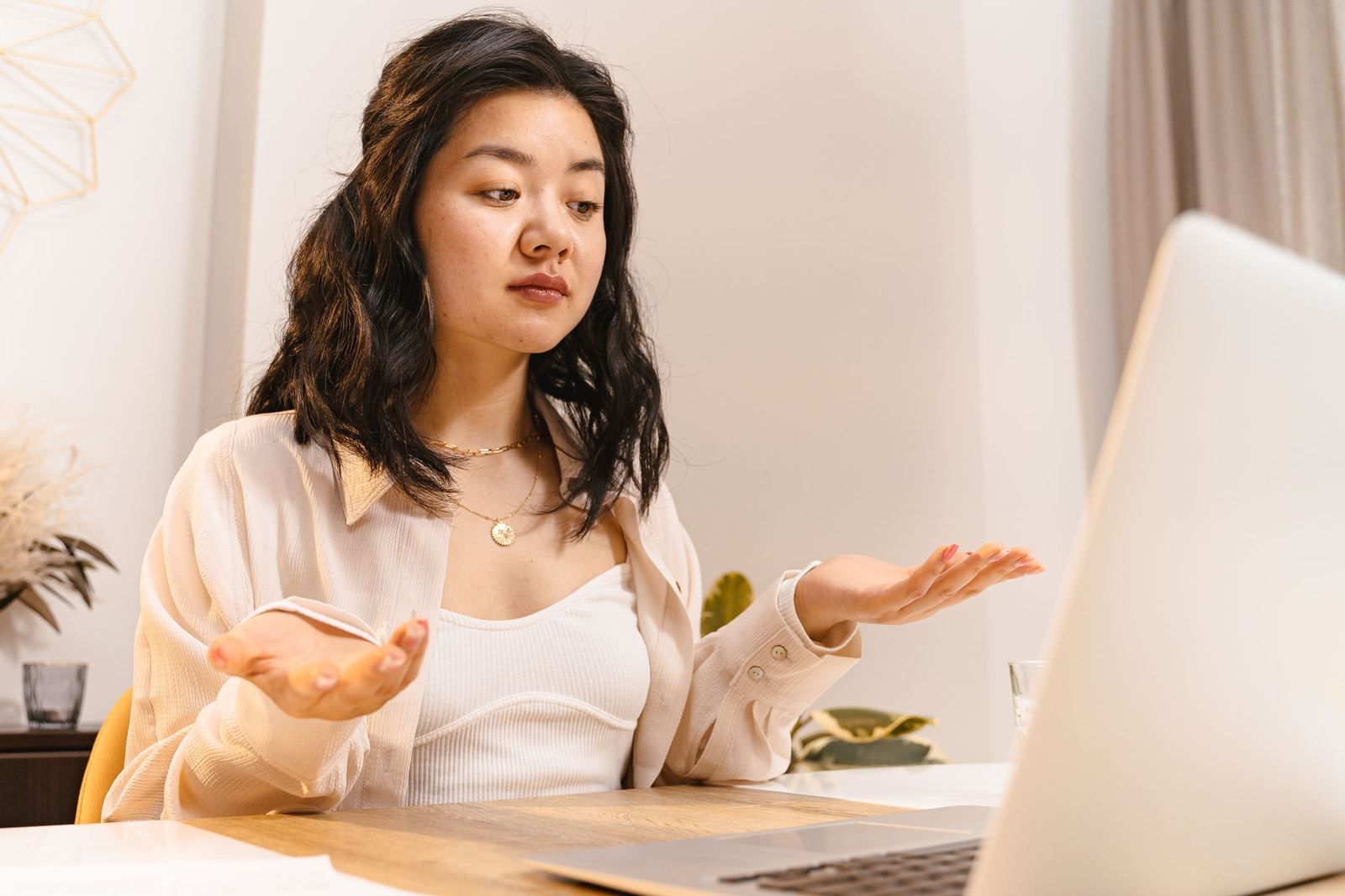 A business owner at her laptop, puzzled by her emails